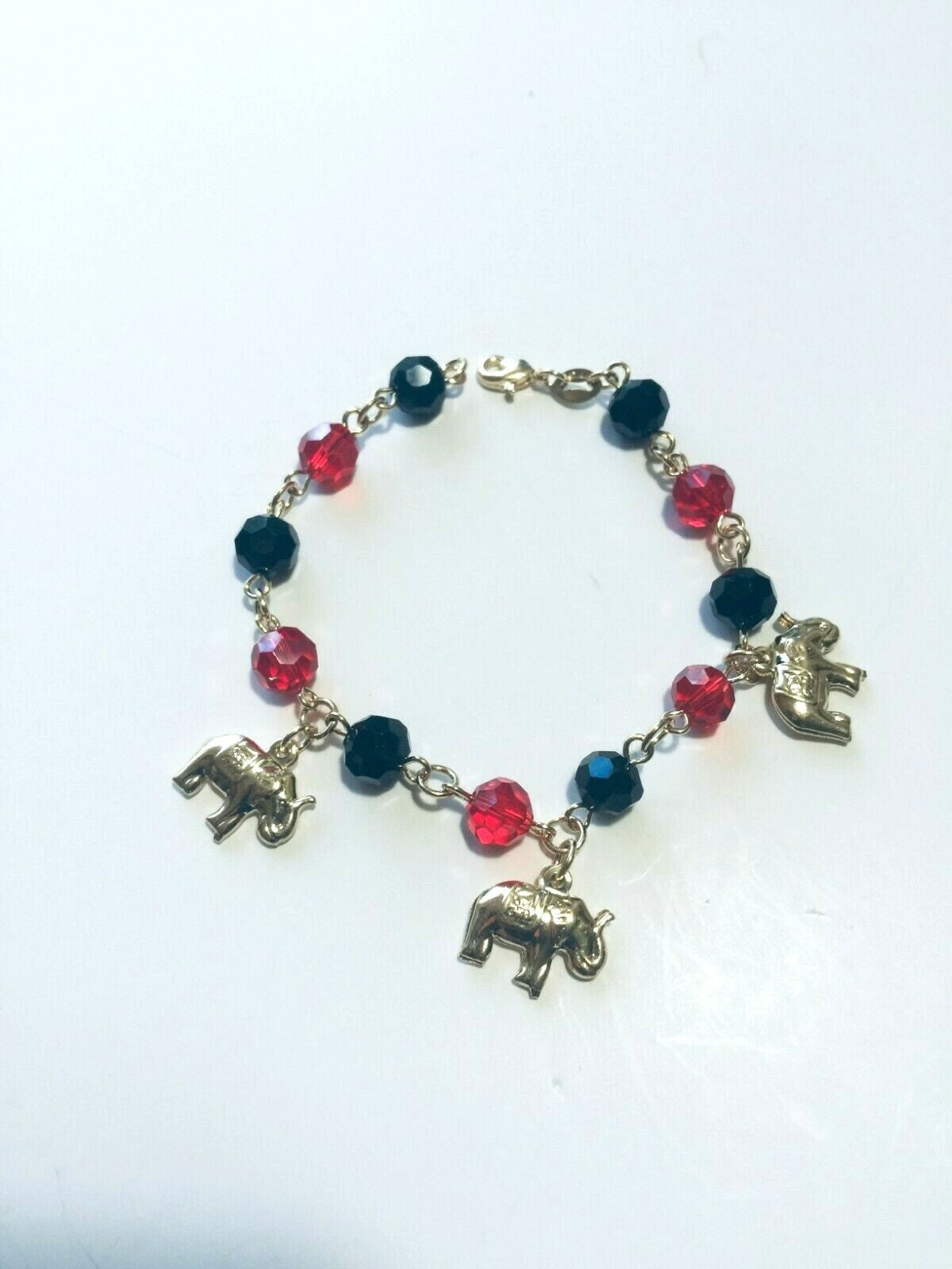 14K GOLD PLATED 7" BRACELET W/7MM BLACK & RED BEADS & 3 ELEPHANTS DANGLING M225