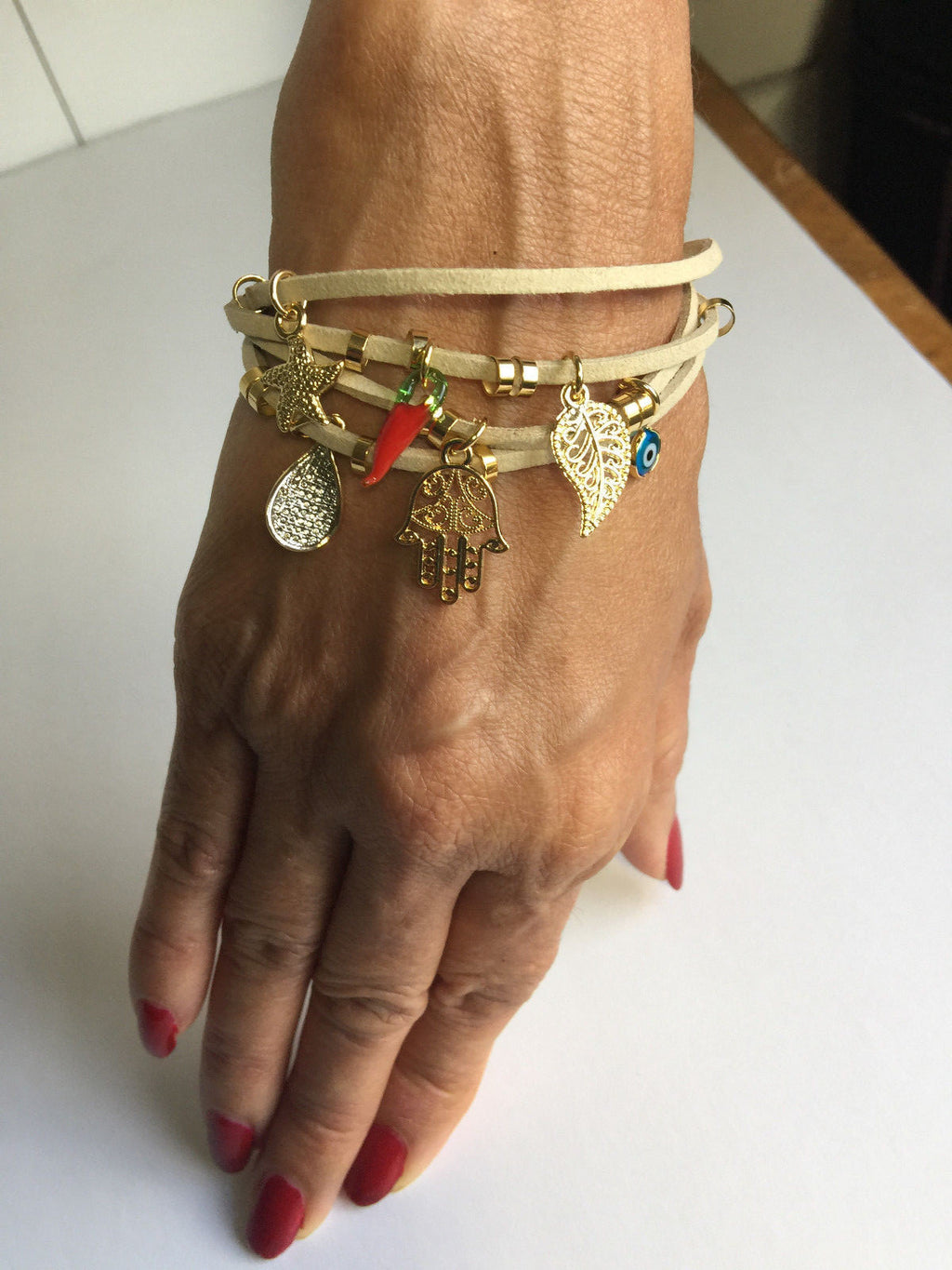 14K GOLD PLATED BRACELET WITH CHARMS DANGLING FROM 4 STRANDS OF BROWN SUEDE J216